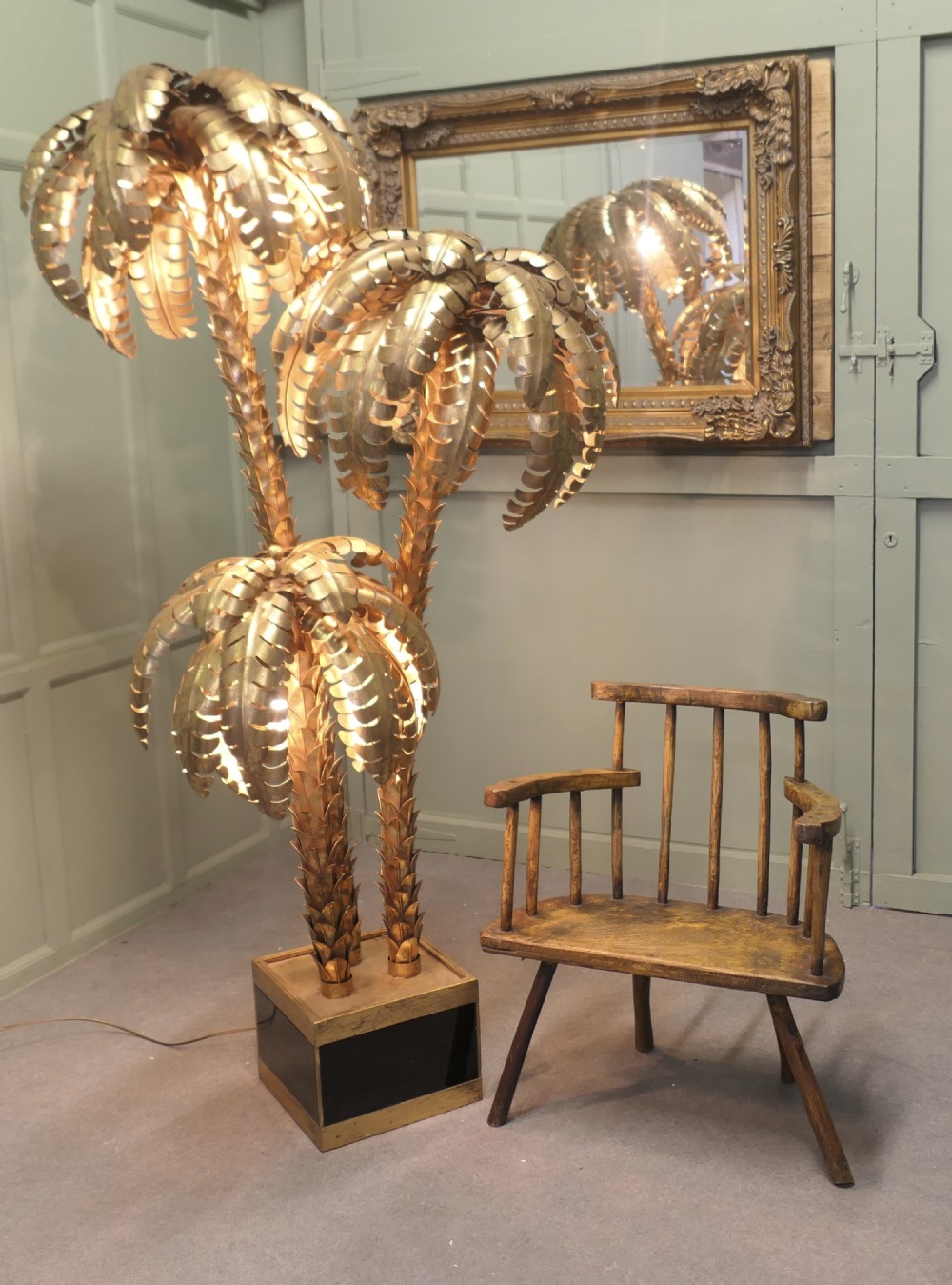 An 18th-century primitive wooden comb-back armchair featuring turned splayed legs, a thick shaped slab seat, and distressed yellow paint finish. View VII