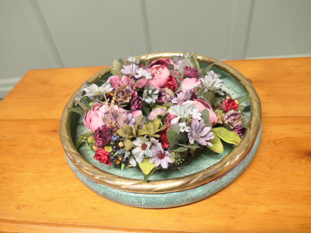A round French copper rose bowl featuring a green verdigris finish and a polished brass rope-twist rim.