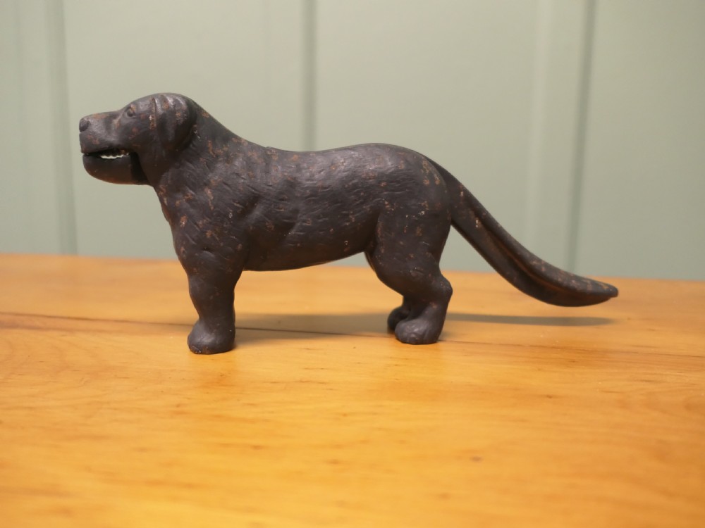 A cast iron mechanical nutcracker crafted in the form of a standing dog with a lever tail mechanism.