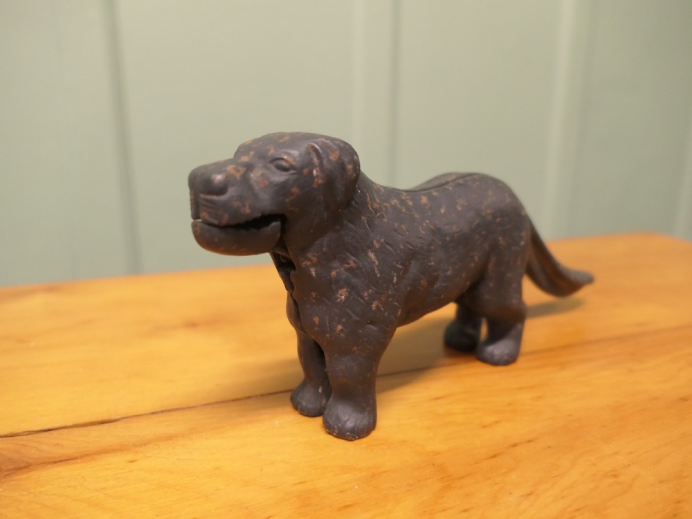 A cast iron mechanical nutcracker crafted in the form of a standing dog with a lever tail mechanism. View II