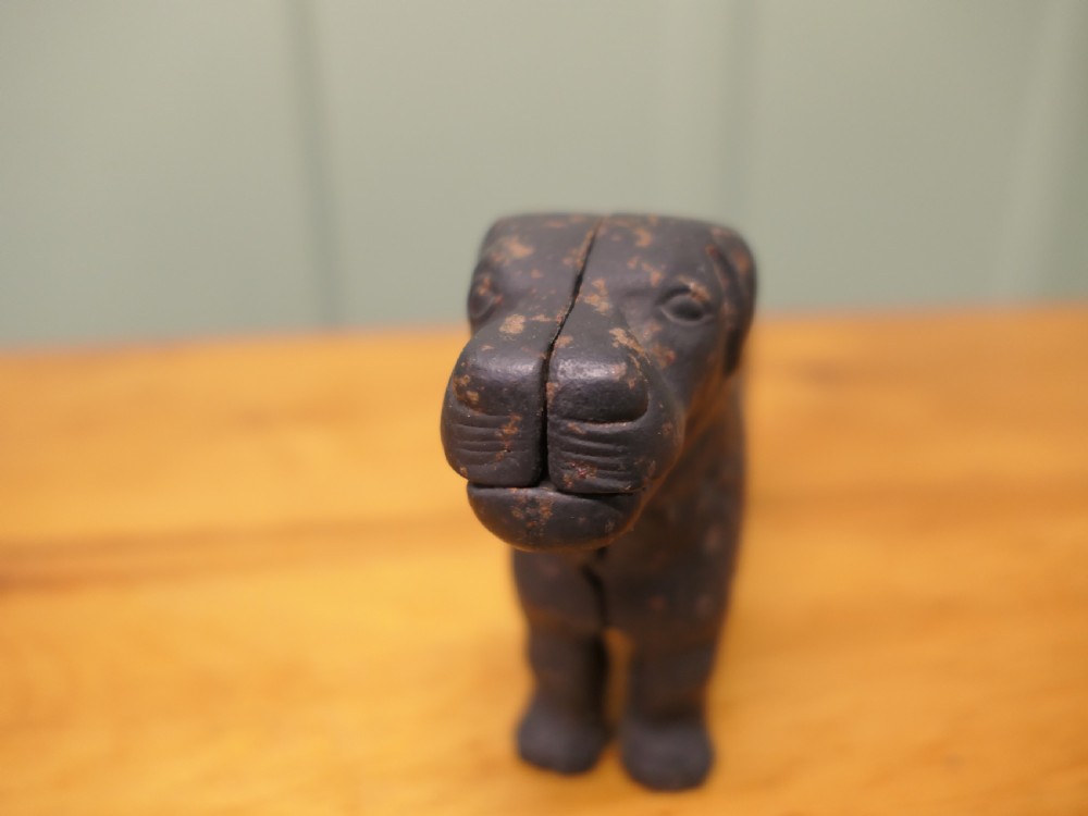 A cast iron mechanical nutcracker crafted in the form of a standing dog with a lever tail mechanism. View III