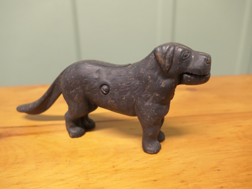 A cast iron mechanical nutcracker crafted in the form of a standing dog with a lever tail mechanism. View IV