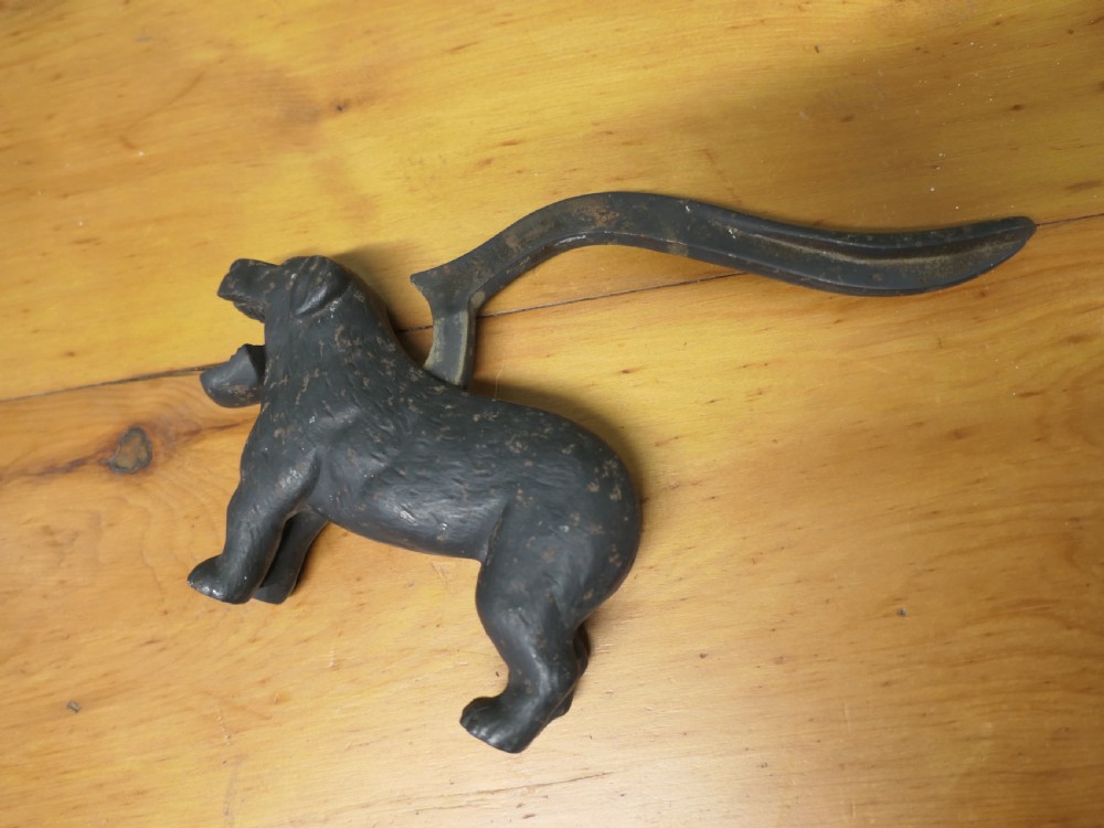 A cast iron mechanical nutcracker crafted in the form of a standing dog with a lever tail mechanism. View V