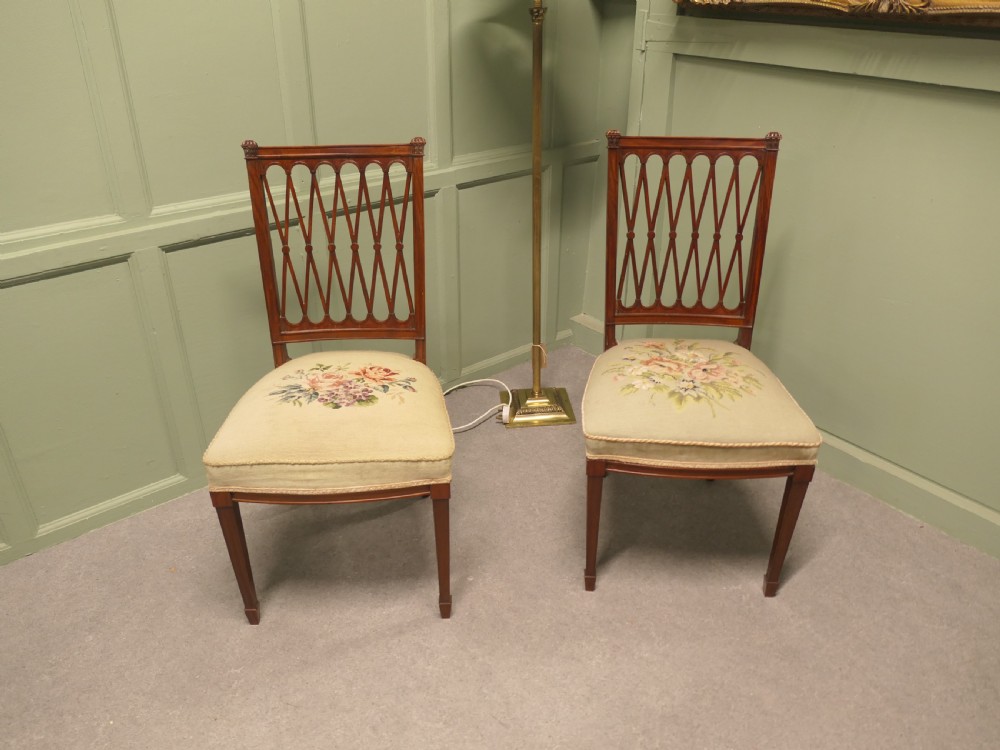 A pair of antique walnut hall chairs with lattice openwork backs and floral needlepoint upholstered seats. View III
