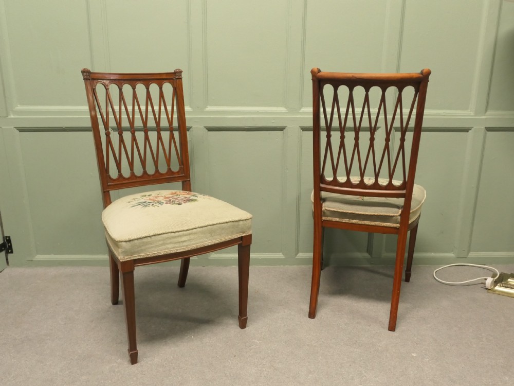 A pair of antique walnut hall chairs with lattice openwork backs and floral needlepoint upholstered seats. View VII