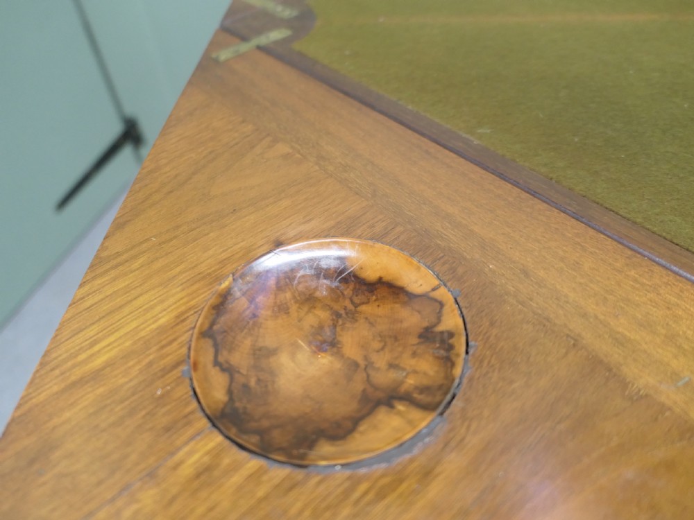 A late Victorian mahogany envelope card table with four triangular flaps unfolding to reveal a central green baize surface and four circular counter wells. View VI
