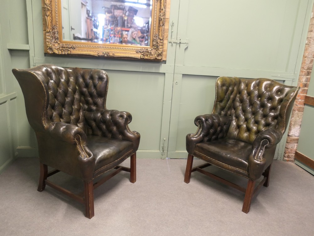 A Pair of Georgian Style Gentleman’s Wing Back Leather Chesterfield Chairs 