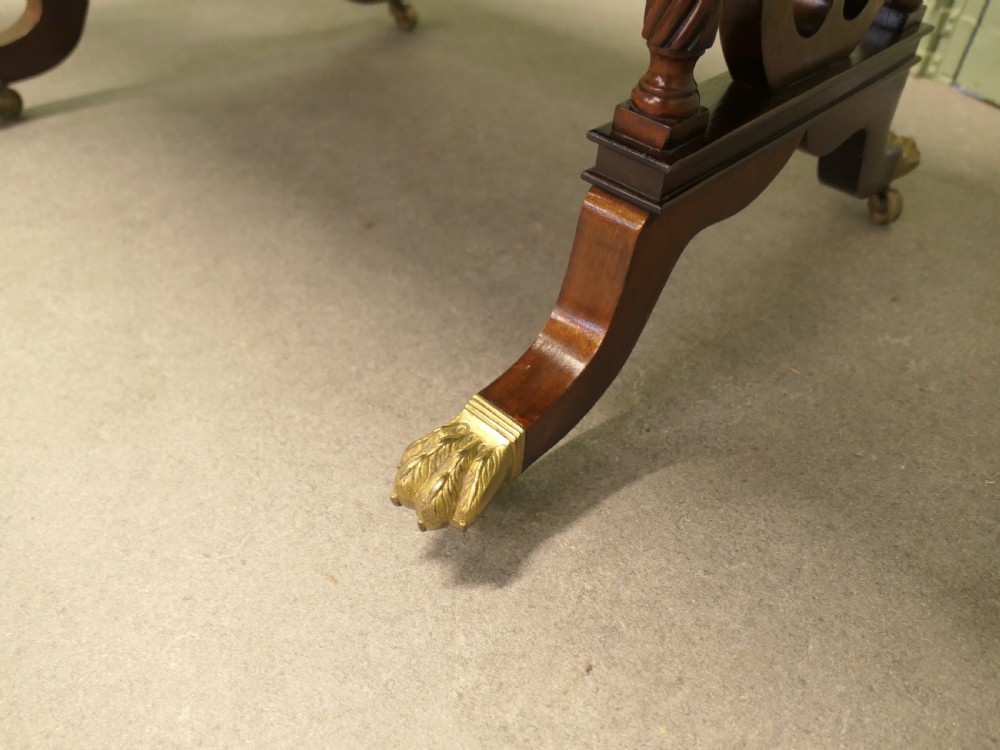 A Regency mahogany sofa table featuring two drop leaves, dual frieze drawers with brass handles, and lyre-shaped end supports terminating in brass lion paw castors. View V
