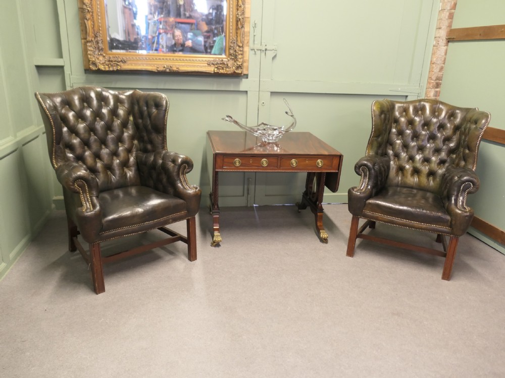 A Regency mahogany sofa table featuring two drop leaves, dual frieze drawers with brass handles, and lyre-shaped end supports terminating in brass lion paw castors. View VII