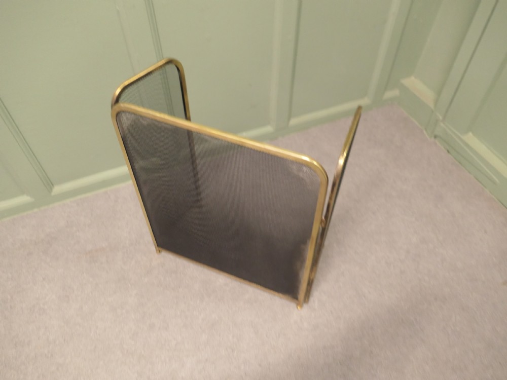 A three-panel folding fire guard featuring a tubular brass frame with black wire mesh screen inserts. View II