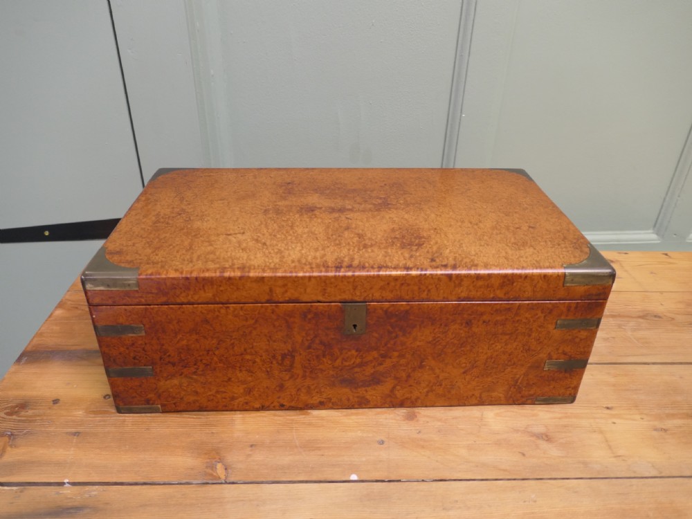 A rectangular 19th century pollard oak writing slope featuring brass corner mounts and a central brass keyhole.