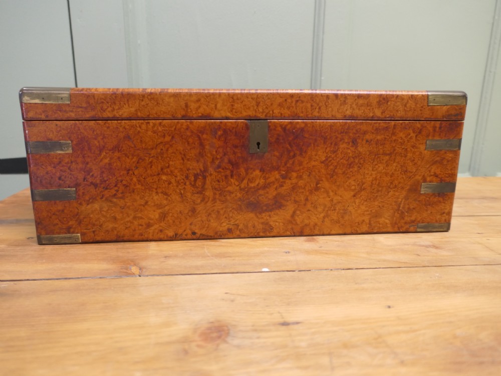 A rectangular 19th century pollard oak writing slope featuring brass corner mounts and a central brass keyhole. View III