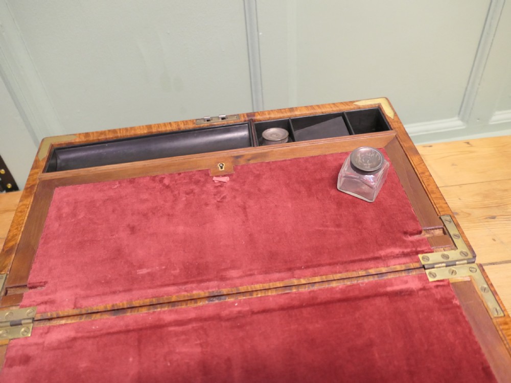 A rectangular 19th century pollard oak writing slope featuring brass corner mounts and a central brass keyhole. View V