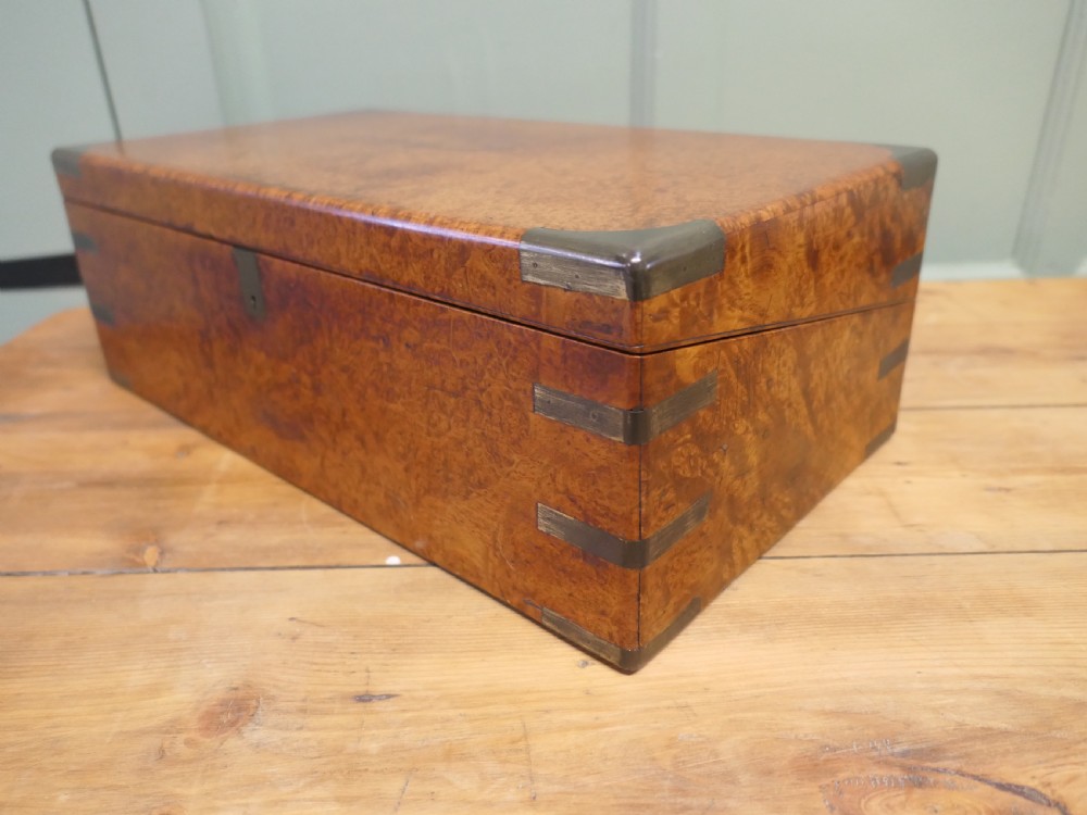 A rectangular 19th century pollard oak writing slope featuring brass corner mounts and a central brass keyhole. View VI