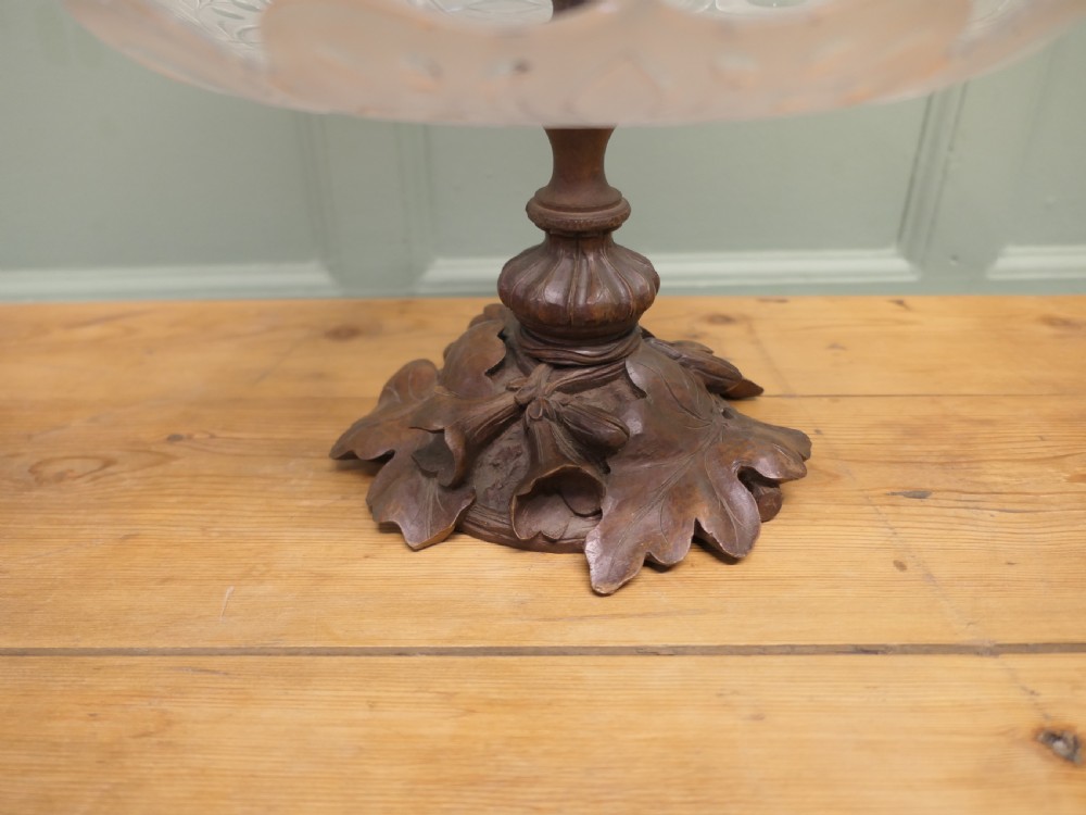 An epergne featuring a central frosted etched crystal trumpet vase and lower tray mounted on a hand-carved dark wood leaf base. View II