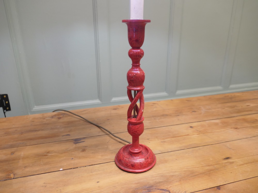 A red painted wooden table lamp featuring an open barley twist stem and a pleated cream lampshade. View II