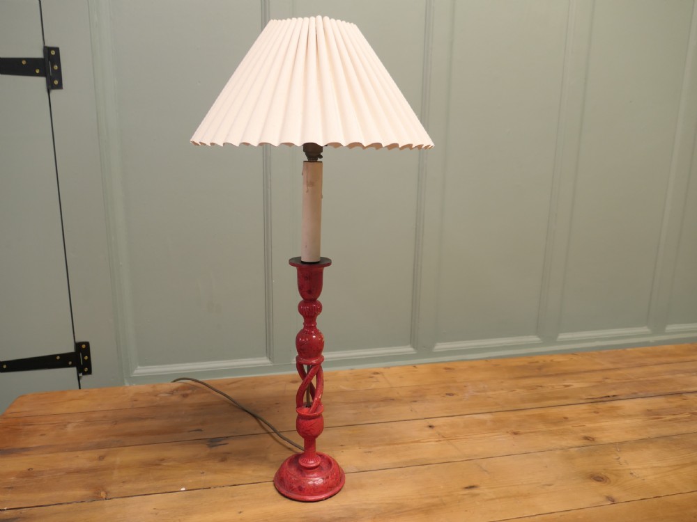 A red painted wooden table lamp featuring an open barley twist stem and a pleated cream lampshade. View VI