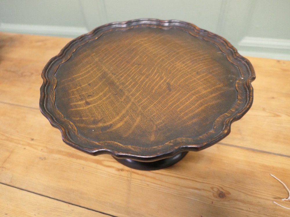 A dark oak Art Deco tazza featuring a scalloped circular tray top supported by a turned pedestal base. View II
