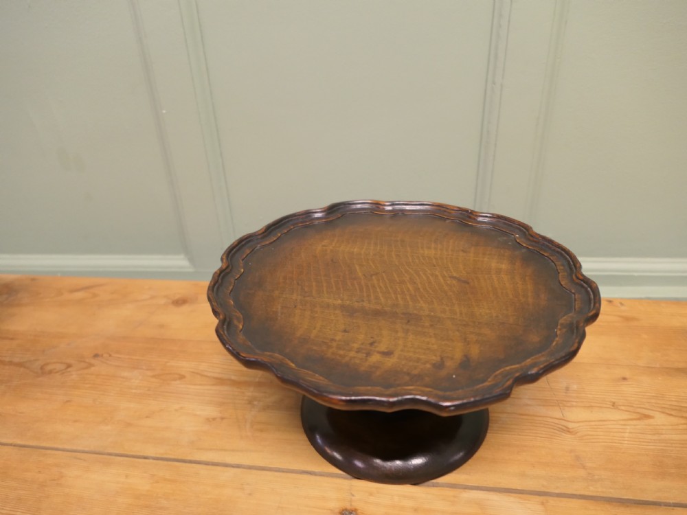 A dark oak Art Deco tazza featuring a scalloped circular tray top supported by a turned pedestal base. View IV