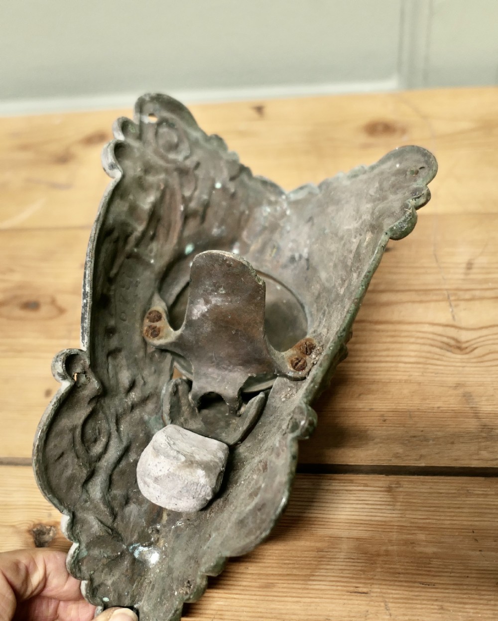 A cast bronze billiard corner pocket decorated with an acanthus leaf relief and a sculpted hand clasping a ball. View VI