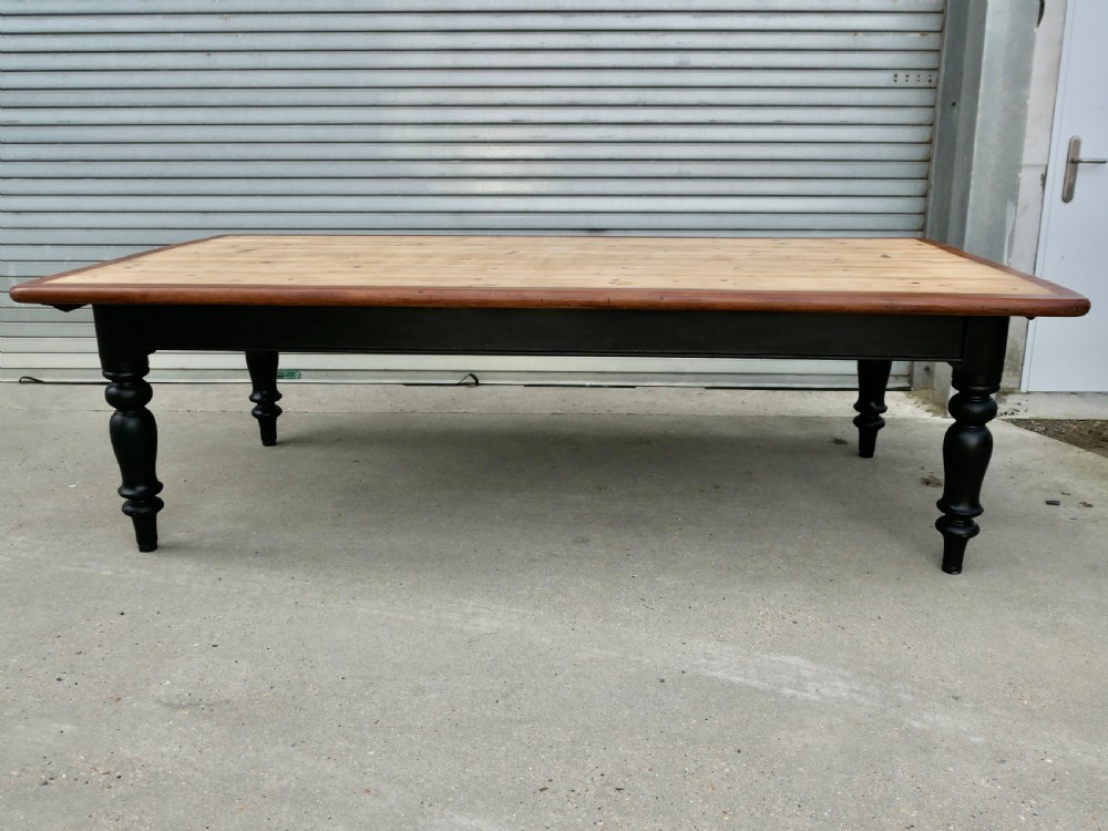 A large Victorian pine farmhouse dining table featuring a natural wood top with dark trim and a black painted base with four turned legs. View III