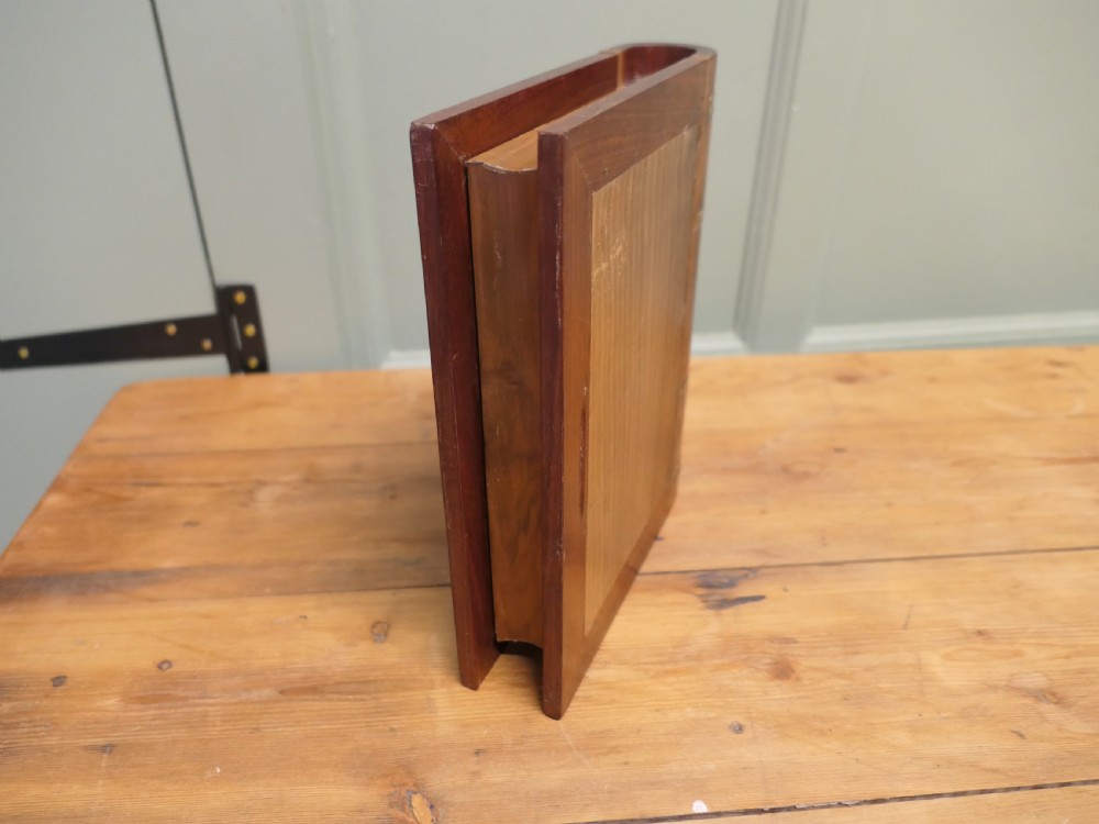 An Art Nouveau carved wooden book-shaped box with brass hinges featuring a relief carving of a seated figure surrounded by organic scrollwork. View VI