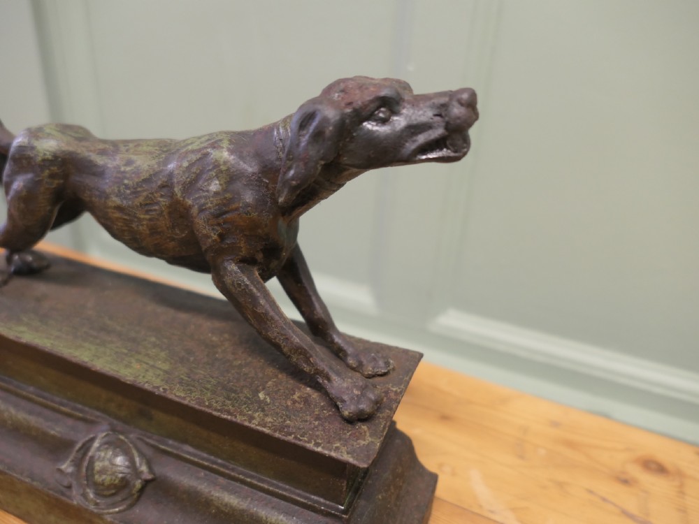 A patinated bronze sculpture of a hunting hound in a pointing posture mounted on a stepped rectangular plinth base. View II