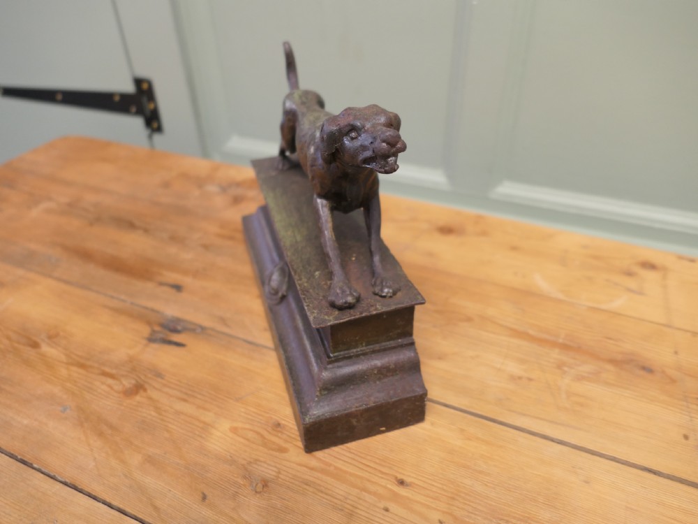 A patinated bronze sculpture of a hunting hound in a pointing posture mounted on a stepped rectangular plinth base. View III