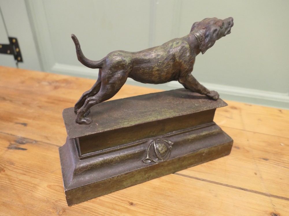 A patinated bronze sculpture of a hunting hound in a pointing posture mounted on a stepped rectangular plinth base. View V
