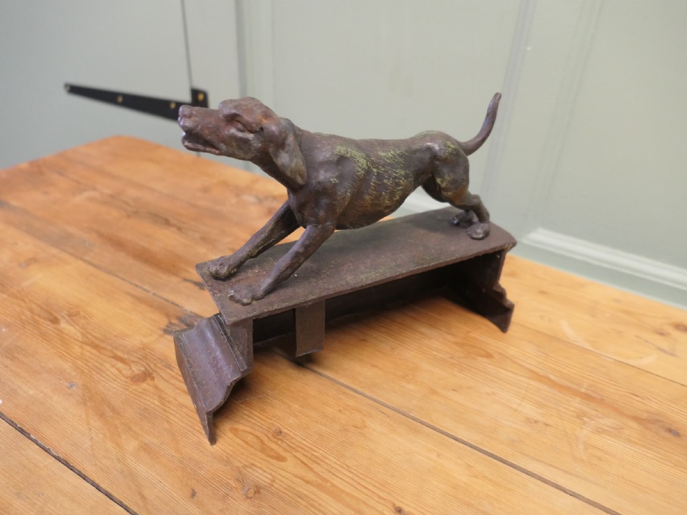 A patinated bronze sculpture of a hunting hound in a pointing posture mounted on a stepped rectangular plinth base. View VI