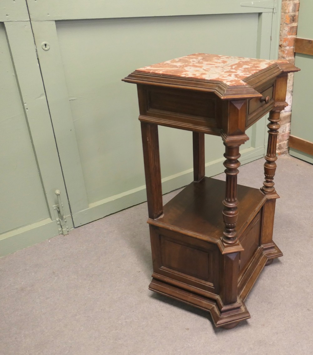 A 19th-century French walnut side cabinet with a pink marble inset top, a single upper drawer, turned columns, an open shelf, and a lower cupboard door. View II