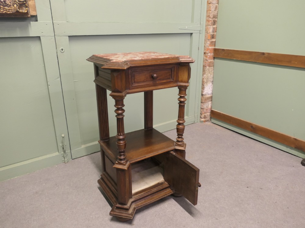 A 19th-century French walnut side cabinet with a pink marble inset top, a single upper drawer, turned columns, an open shelf, and a lower cupboard door. View III