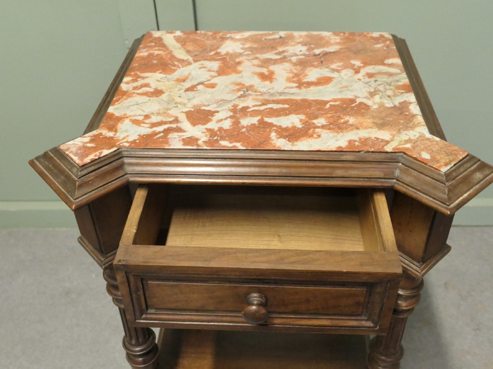 A 19th-century French walnut side cabinet with a pink marble inset top, a single upper drawer, turned columns, an open shelf, and a lower cupboard door. View VII