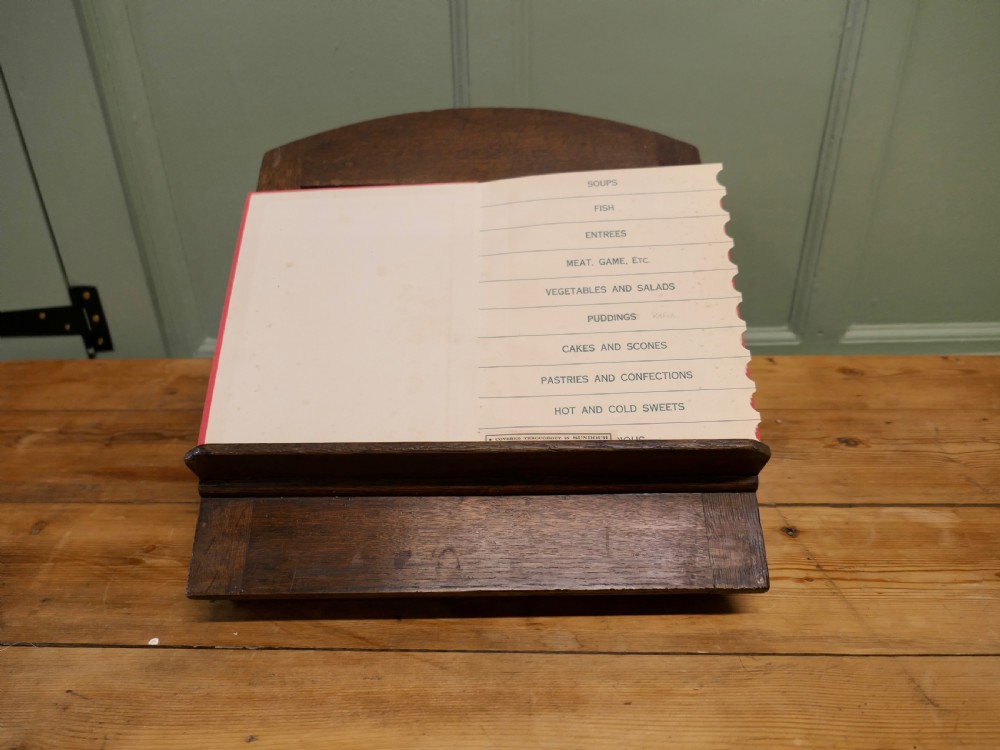 A solid dark oak sloped book rest featuring a wooden ledge and an adjustable hinged rear support. View II