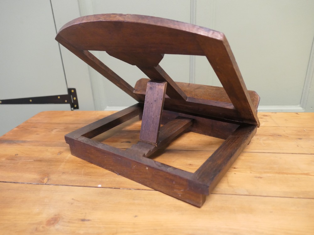 A solid dark oak sloped book rest featuring a wooden ledge and an adjustable hinged rear support. View III