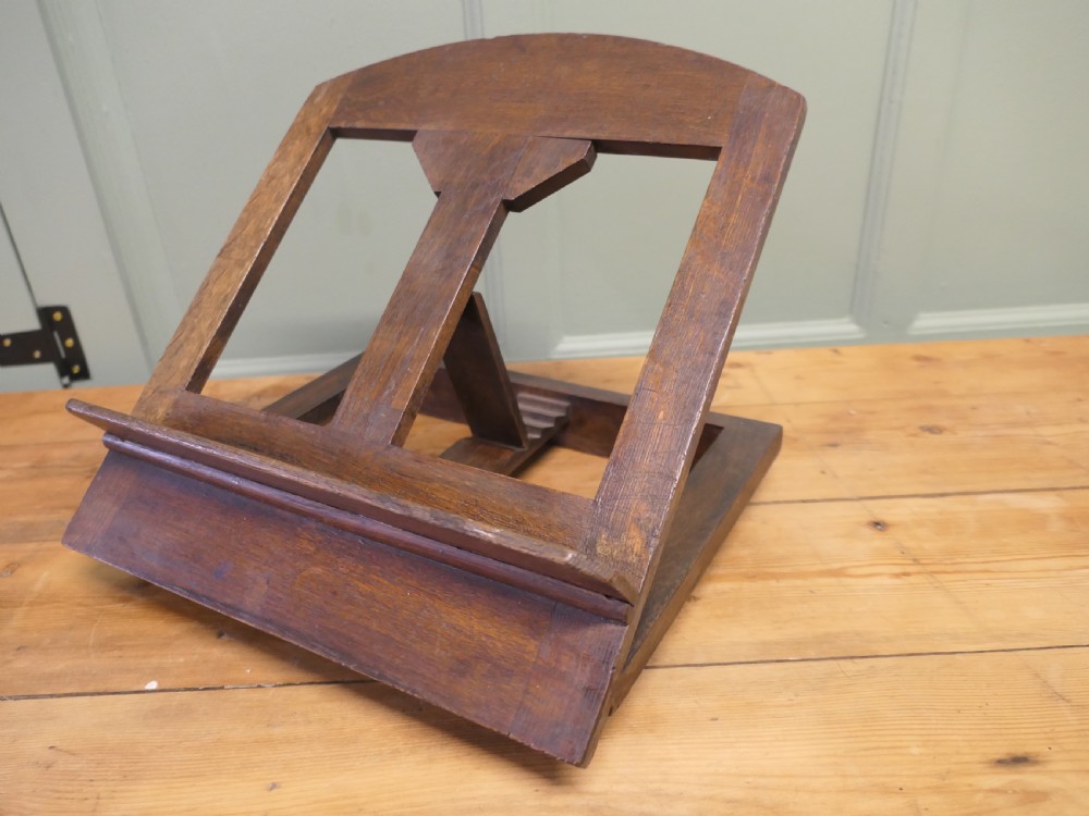 A solid dark oak sloped book rest featuring a wooden ledge and an adjustable hinged rear support. View V