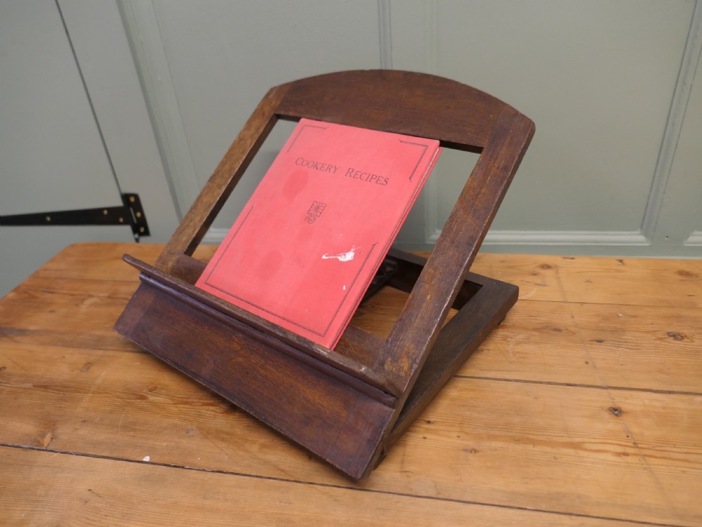 A solid dark oak sloped book rest featuring a wooden ledge and an adjustable hinged rear support. View VI
