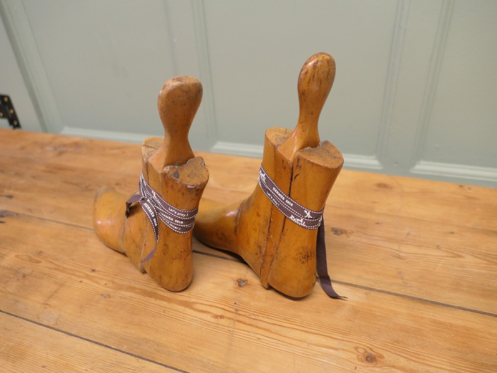 A pair of 19th-century carved wooden ladies ankle boot stretchers featuring smooth contoured timber sections and shaped top handles.