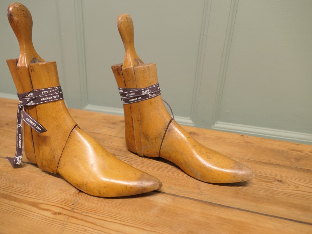 A pair of 19th-century carved wooden ladies ankle boot stretchers featuring smooth contoured timber sections and shaped top handles. View II