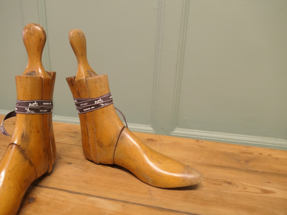 A pair of 19th-century carved wooden ladies ankle boot stretchers featuring smooth contoured timber sections and shaped top handles. View III