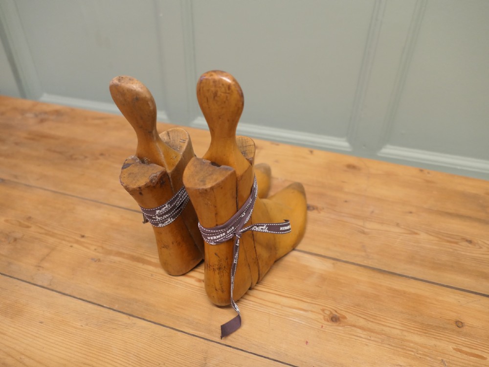A pair of 19th-century carved wooden ladies ankle boot stretchers featuring smooth contoured timber sections and shaped top handles. View V