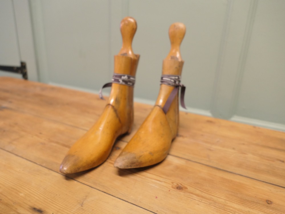 A pair of 19th-century carved wooden ladies ankle boot stretchers featuring smooth contoured timber sections and shaped top handles. View VI