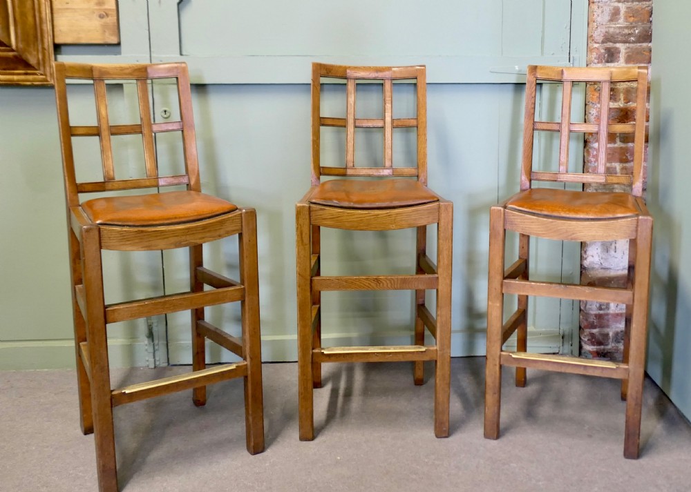 A Good Trio of Arts and Crafts High Bar Stools, in Leather and Golden Oak