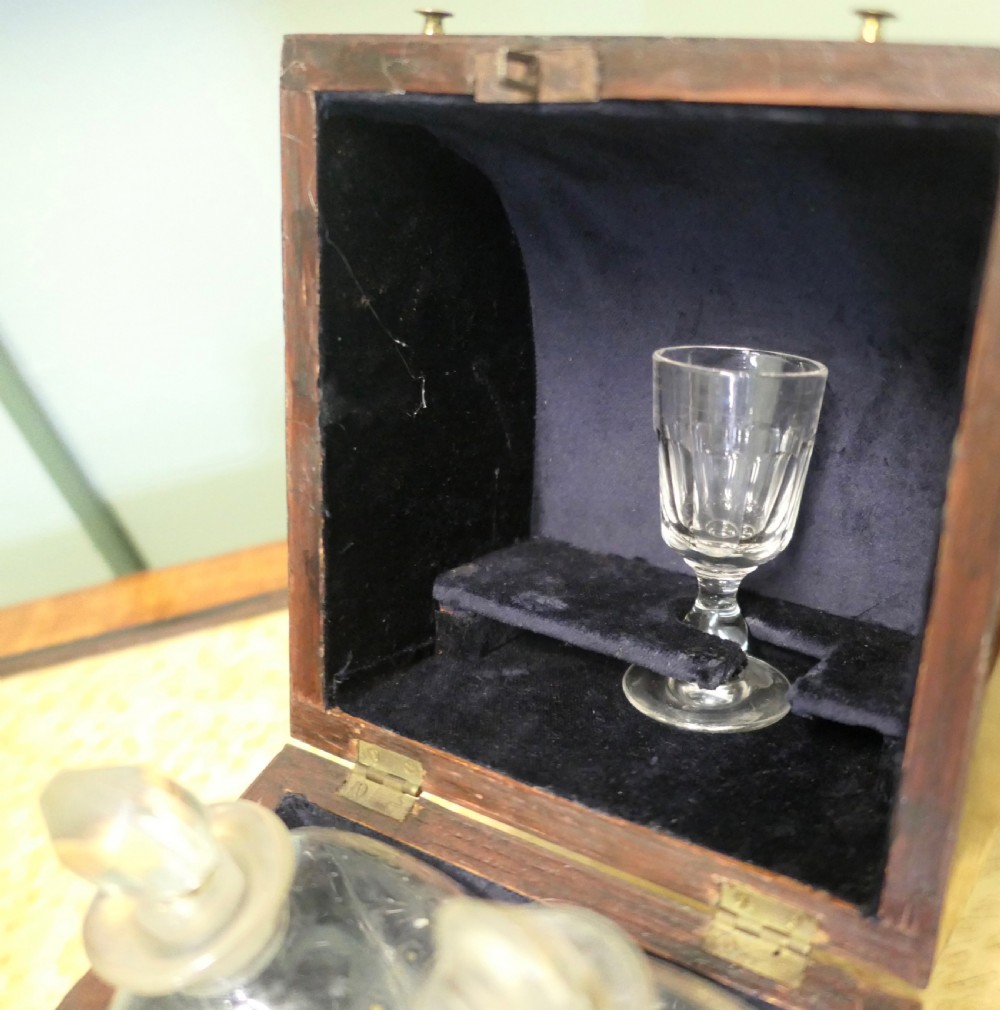 A 19th-century wooden decanter box featuring a curved top, warm brown grain, brass fittings, and a key inserted into the front lock. View IV