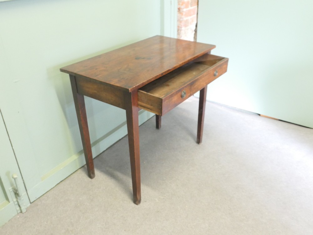 An early nineteenth-century warm brown oak writing table featuring a single frieze drawer with brass ring handles and four square tapered legs. View III