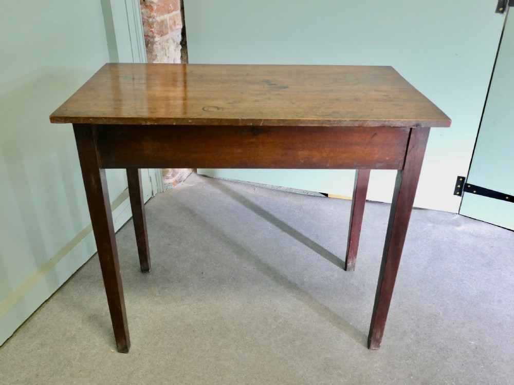 An early nineteenth-century warm brown oak writing table featuring a single frieze drawer with brass ring handles and four square tapered legs. View VI