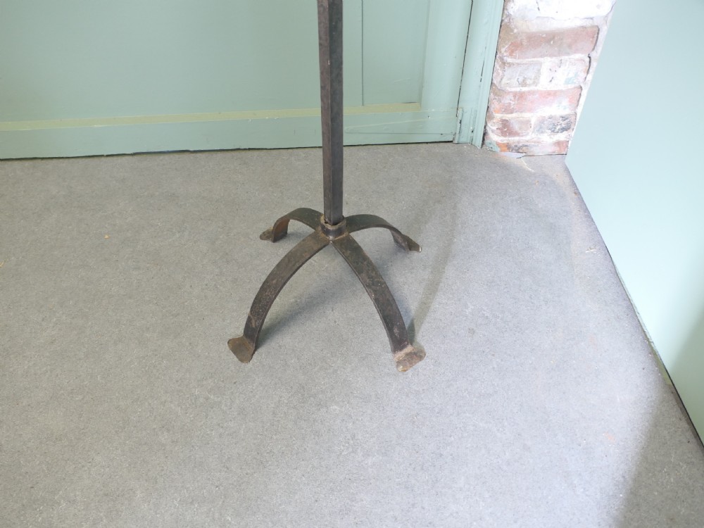A tall wrought iron floor-standing candelabra featuring a twisted central stem, an arched four-legged base, and five candle holders on crossbars. View III