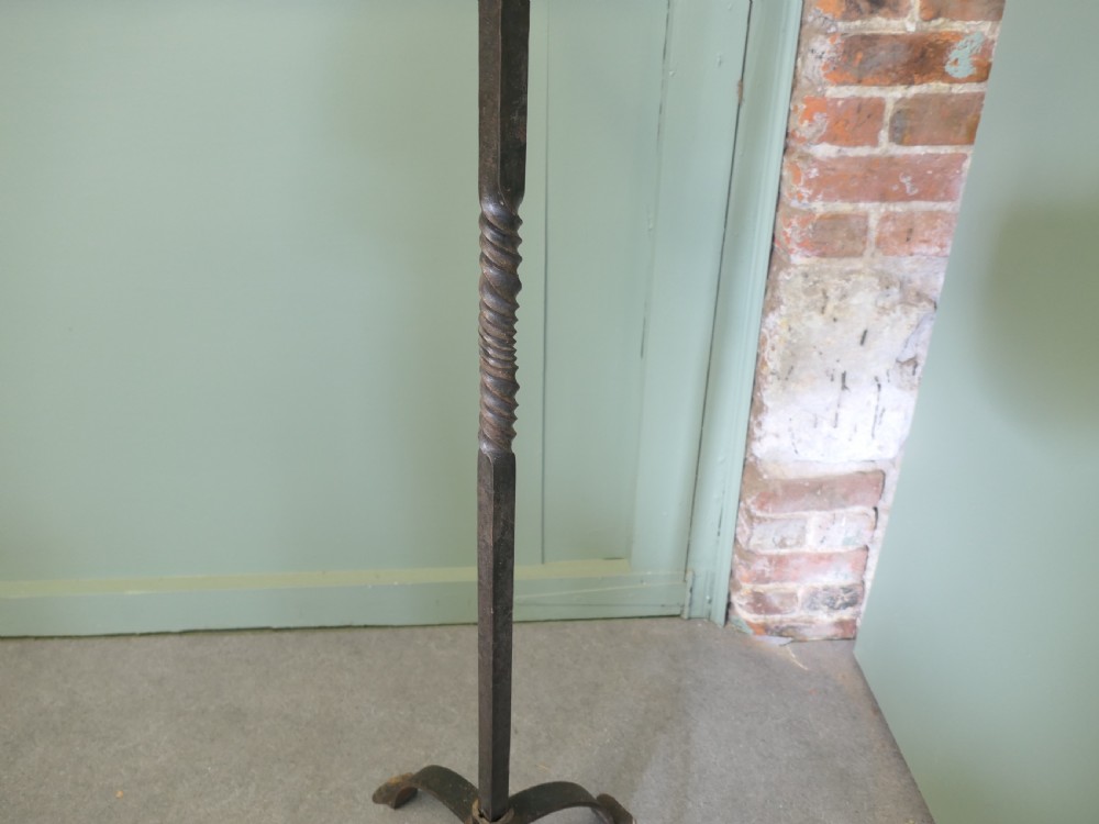 A tall wrought iron floor-standing candelabra featuring a twisted central stem, an arched four-legged base, and five candle holders on crossbars. View VI