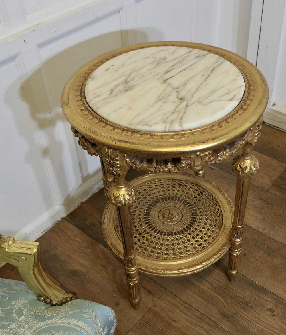 A pair of 19th-century French giltwood salon armchairs upholstered in light blue and cream patterned damask. View III
