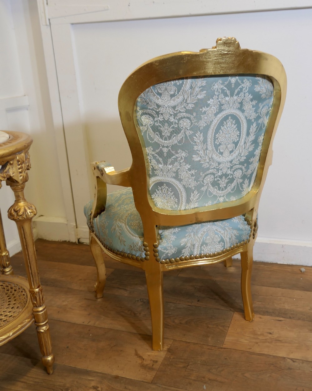 A pair of 19th-century French giltwood salon armchairs upholstered in light blue and cream patterned damask. View VI